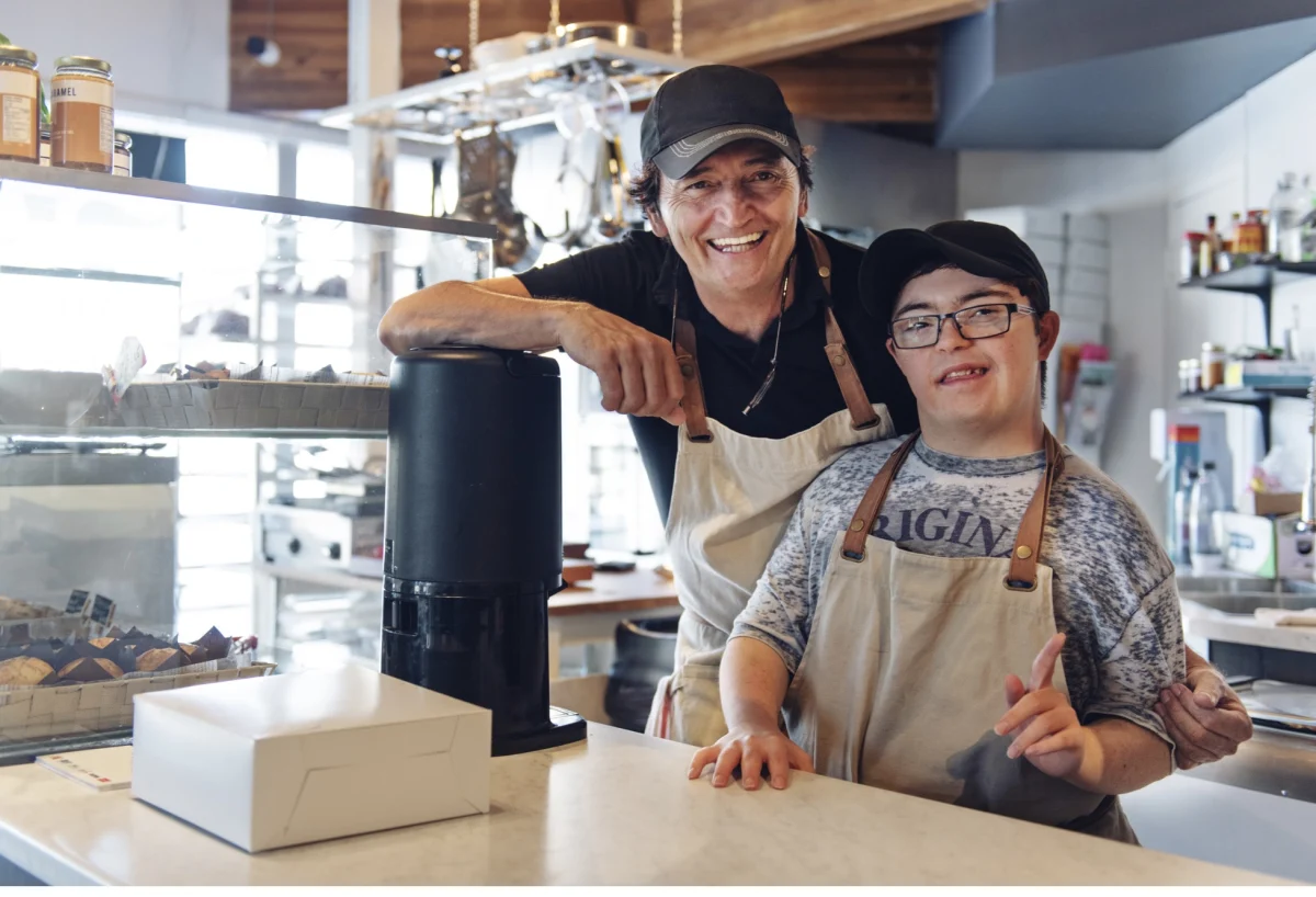 Two people smiling together in a cafe
